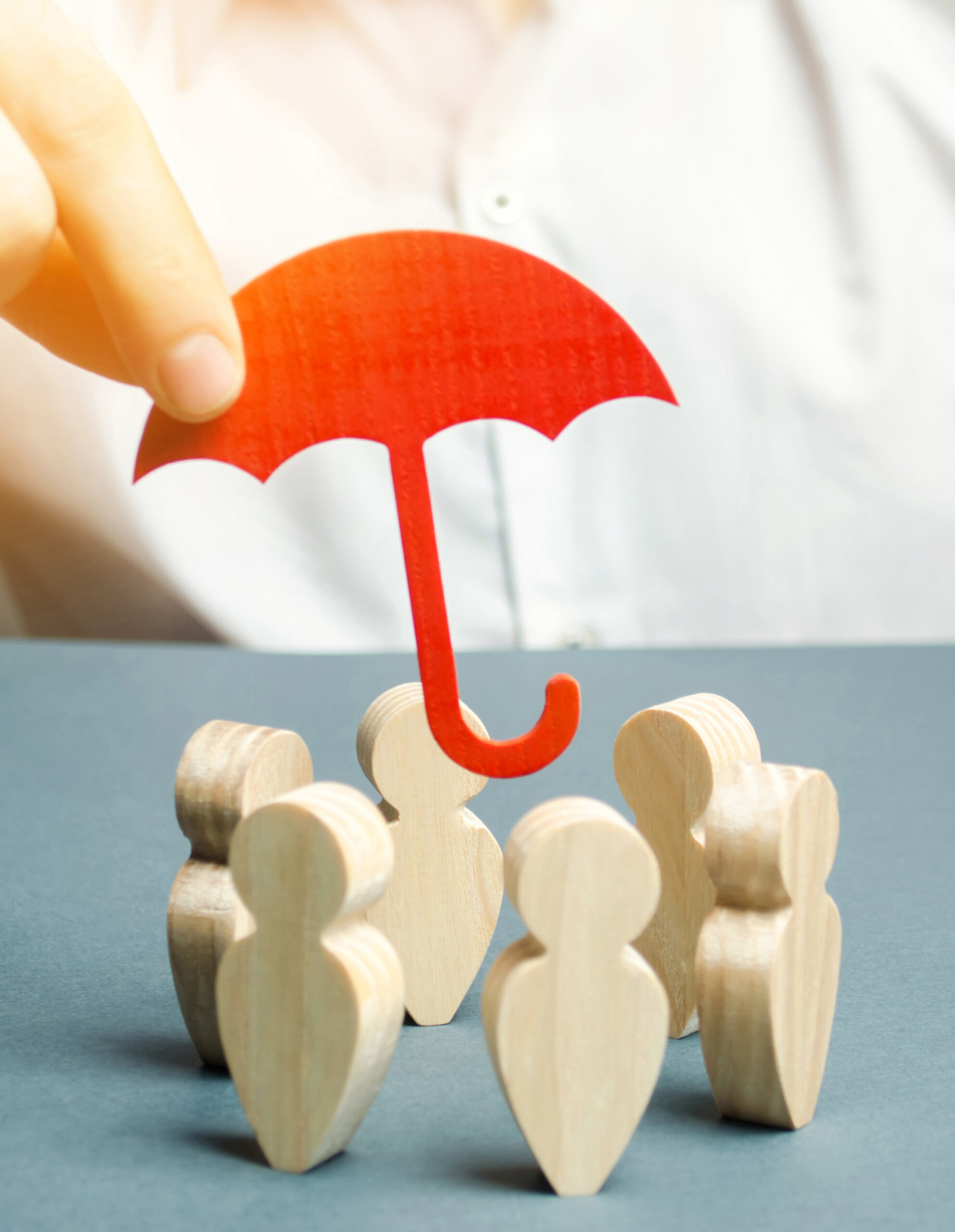 Boss defending his team with a gesture of protection. Life insurance. Customer care, care for employees. Security and safety in a business team. Selective focus